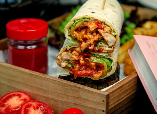 chicken wraps in flatbread dipped into ketchup