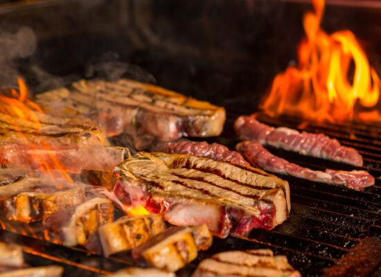 half-grilled-half-ready-raw-steaks-grill